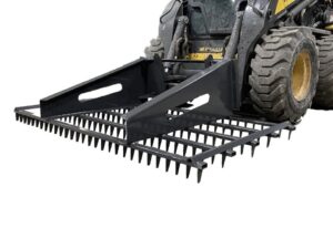 A Skid Steer Track Tool featuring a large metal rake attachment at the front, making it the ultimate New Holland equipment for heavy-duty tasks.