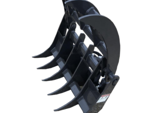 A black, heavy-duty Dingo Root Rake with multiple curved tines sits on a gravel surface.