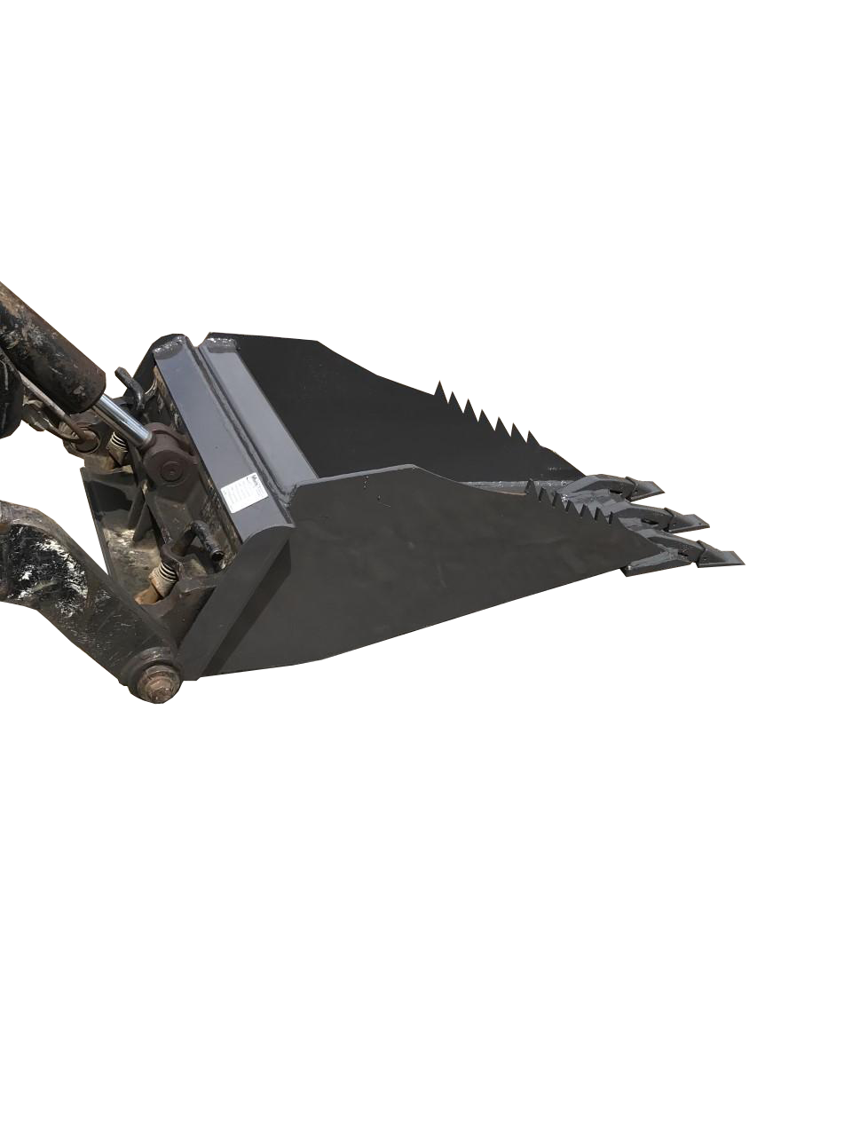 A black Dingo Stump Bucket with serrated edges rests on a dirt surface, attached to a Dingo construction machine at the site.