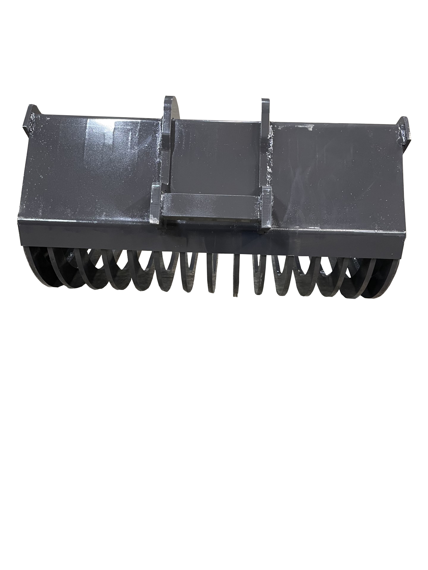 A large, black mechanical attachment with ridged rollers and a square mounting bracket, resembling a Bobcat Skeleton Excavator Bucket, placed on a gray concrete floor.